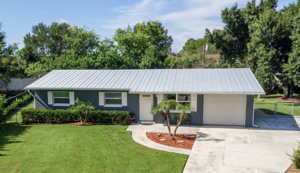 Quaint-Starter-Home-With-Metal-Roof-And-Freshly-Painted-With-Beautiful-Green-Lawn-In-Cape-Coral-Florida